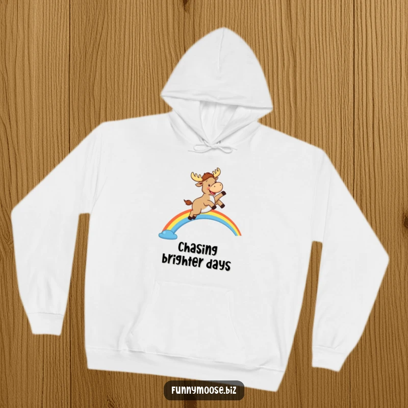 Funny Kawaii Moose Hoodie: A happy cartoon moose leaps over a rainbow, cozy apparel for joy lovers.