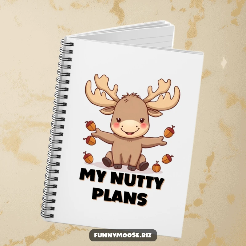 Funny kawaii moose with large antlers juggling acorns, featured on a notebook cover for woodland inspiration.